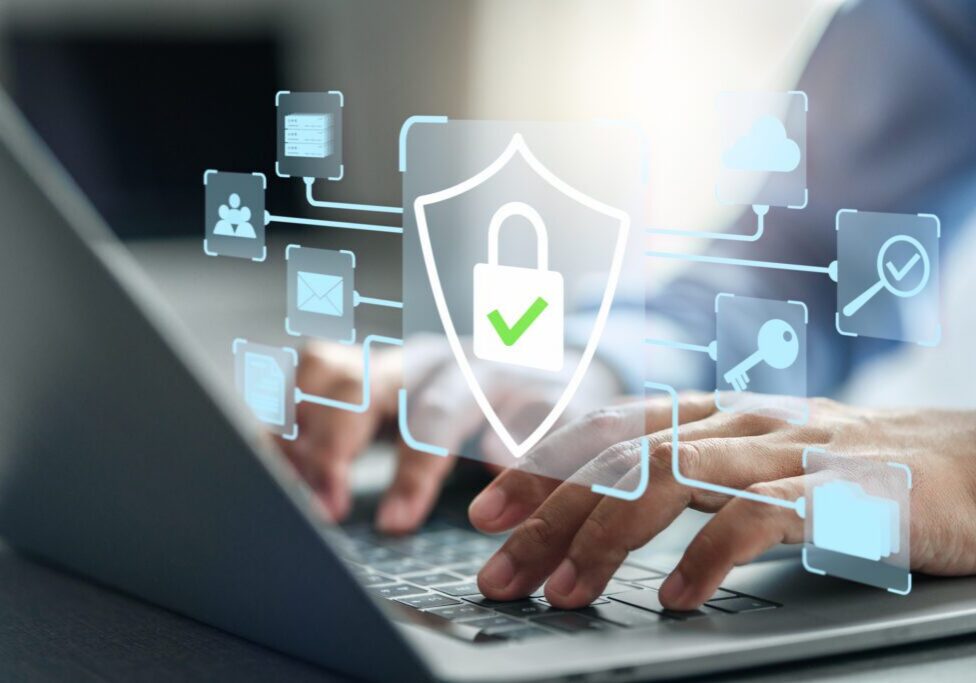 Hands typing with digital security shield overlay